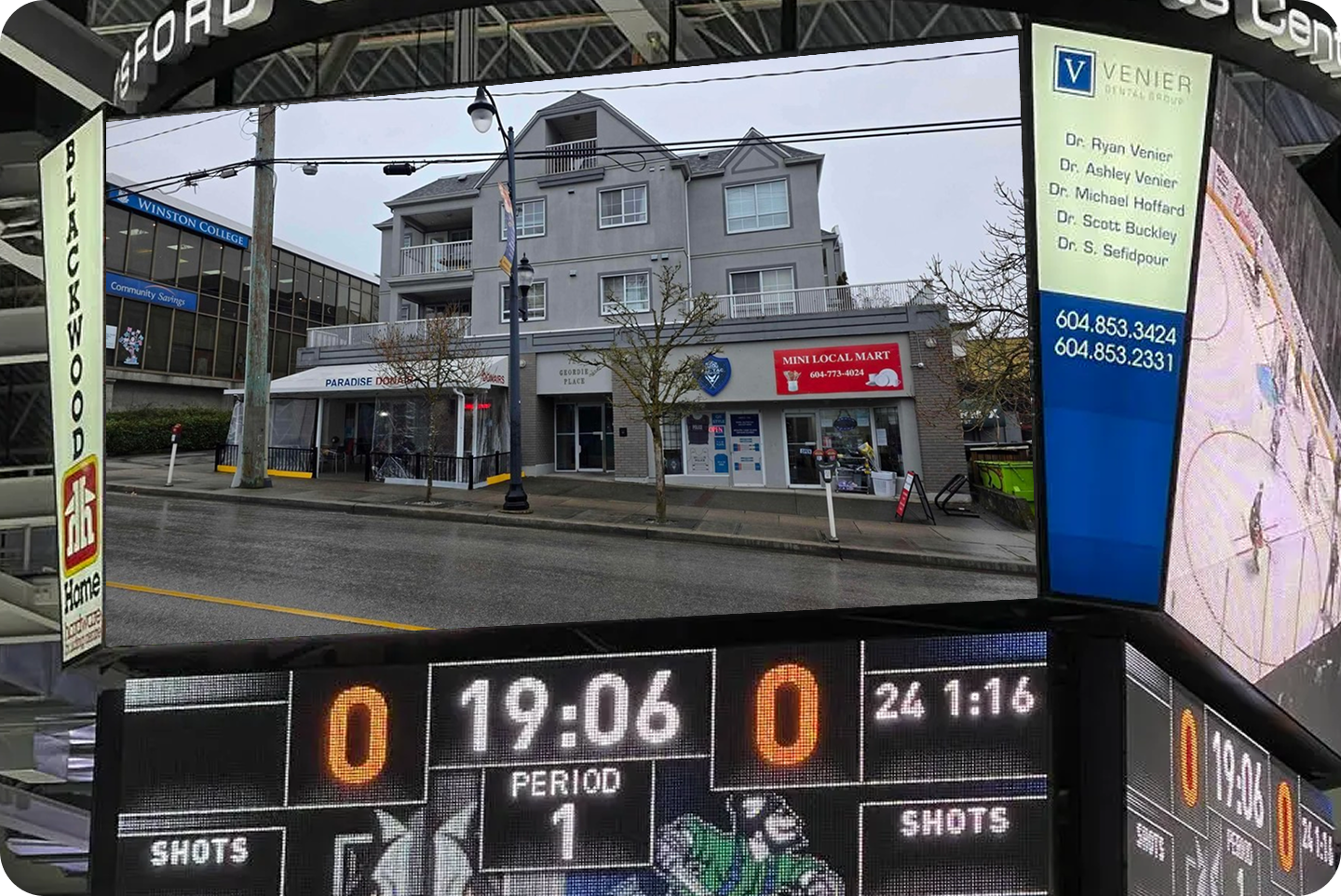 An arena jumbotron showing a photograph of a three storey New Westminster apartment building above a hockey scoreboard reading nil to nil in the first period