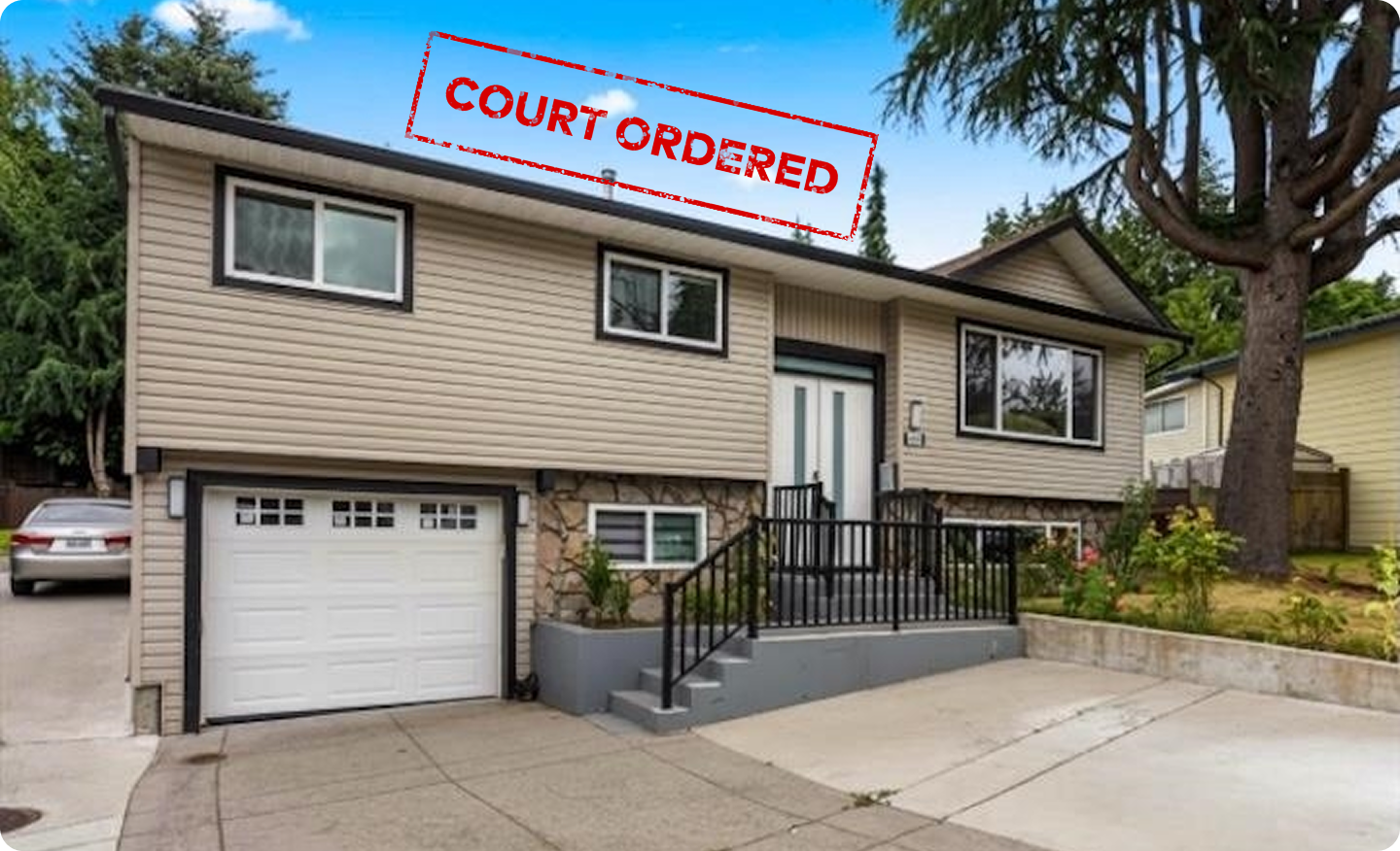 A two storey Surrey family home with a white garage door and mature trees behind it, stamped Court Ordered in red across the top of the photograph