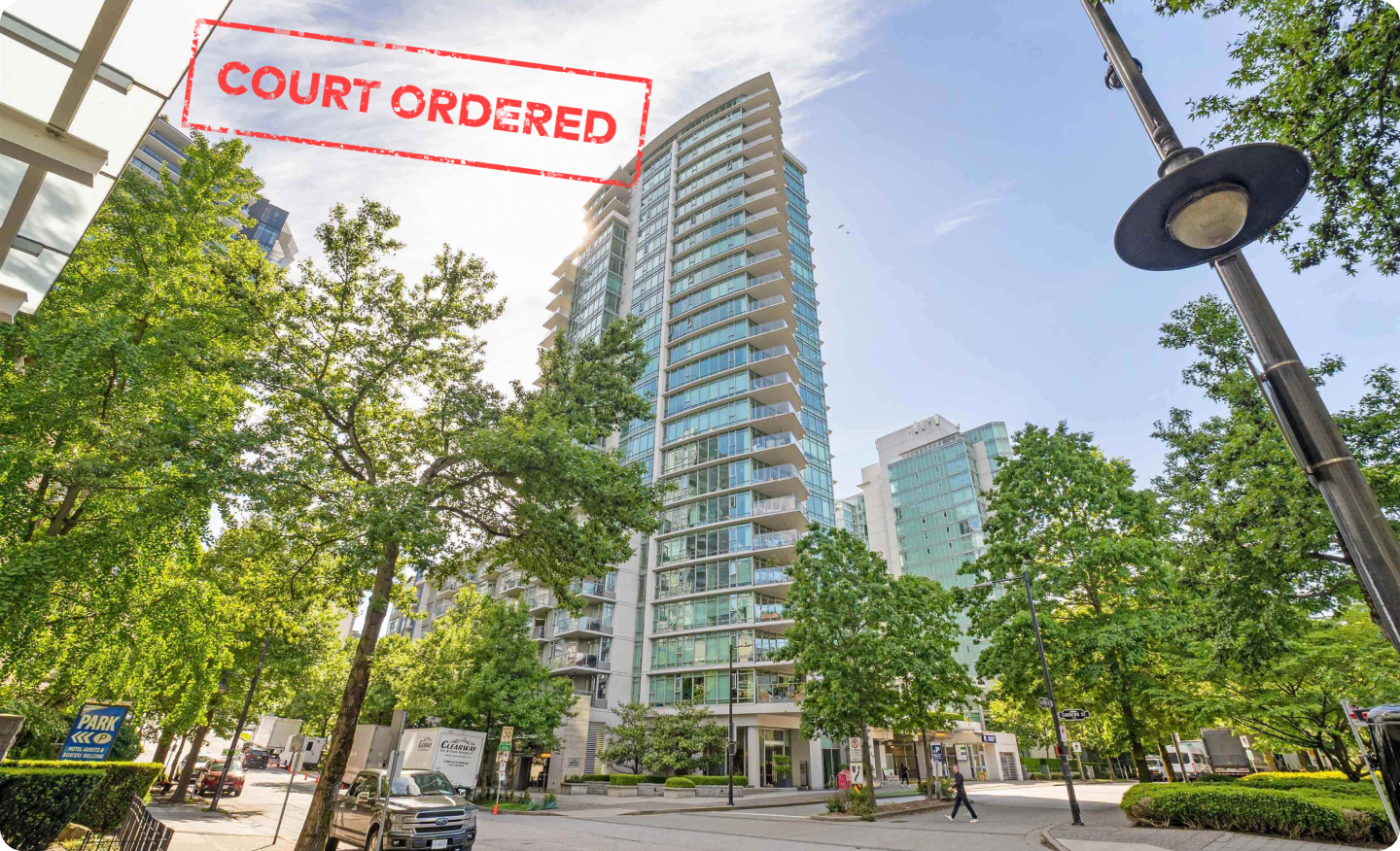 A Coal Harbour glass condo tower on Bayshore Drive framed by street trees and a lamp post, stamped Court Ordered in red across the top of the photograph